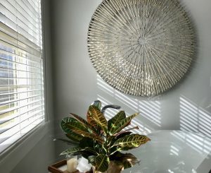 Woven wheel hanging on wall in spa bathroom