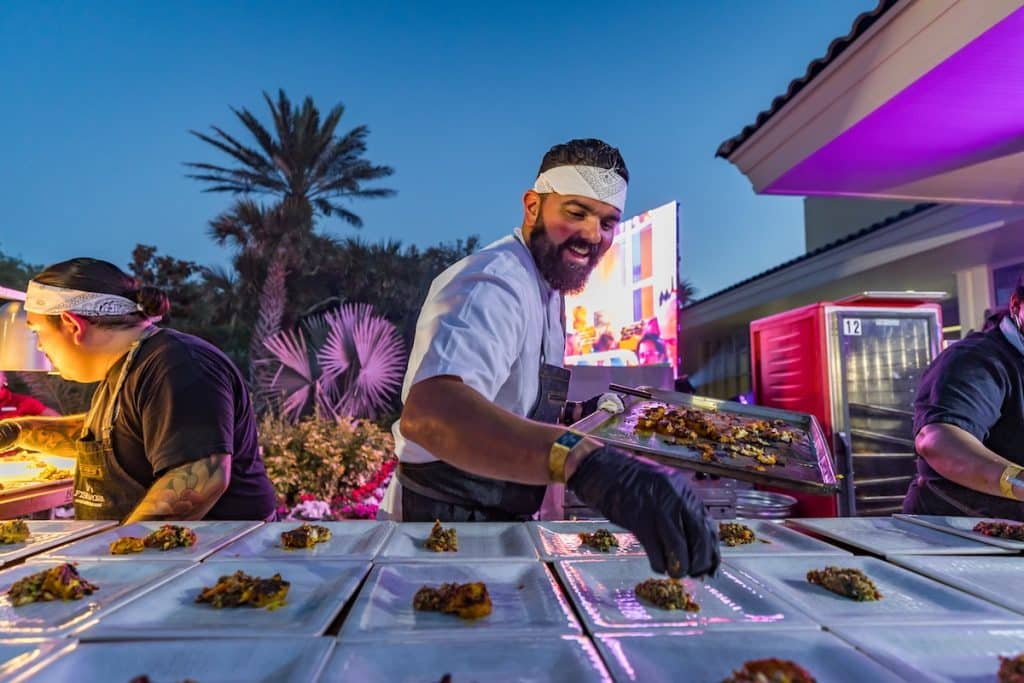Chef prepping plates during the Fish to Fork event at Omni Amelia Island.
