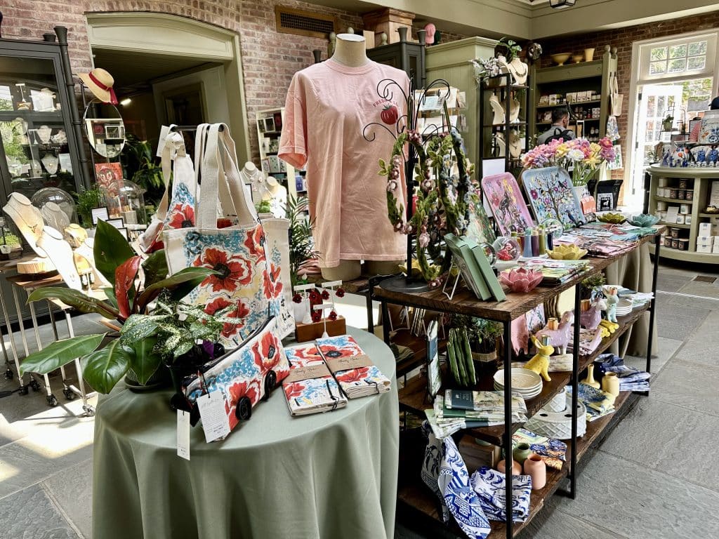 Interior of the Wave Hill Garden gift shop with tables of garden-related items for sale.