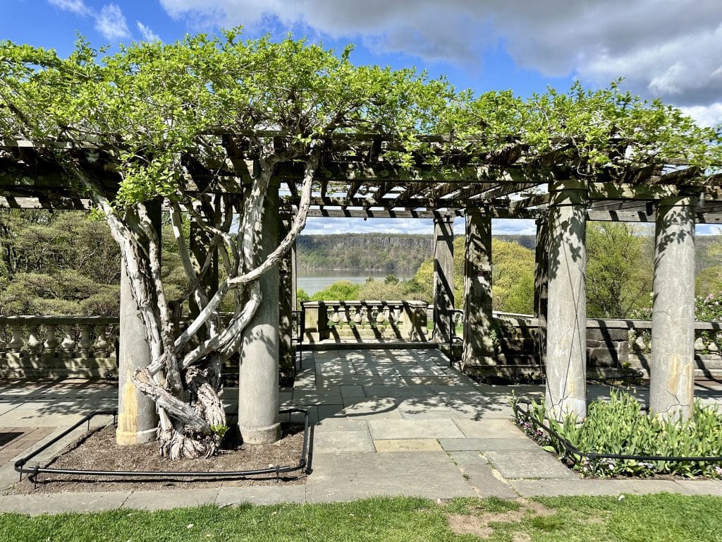 Pergola at Wave Hill Garden with view overlooking the Hudson River and New Jersey Palisades.